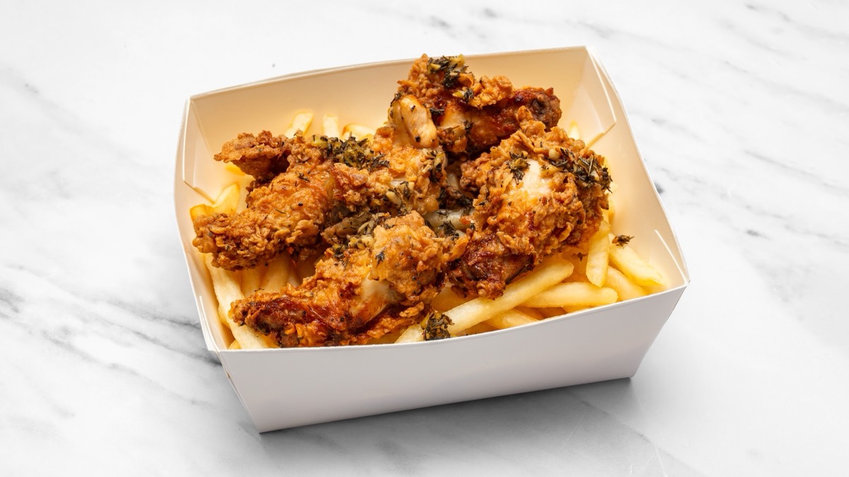 Crispy fried chicken tossed in lemon and thyme over chips
